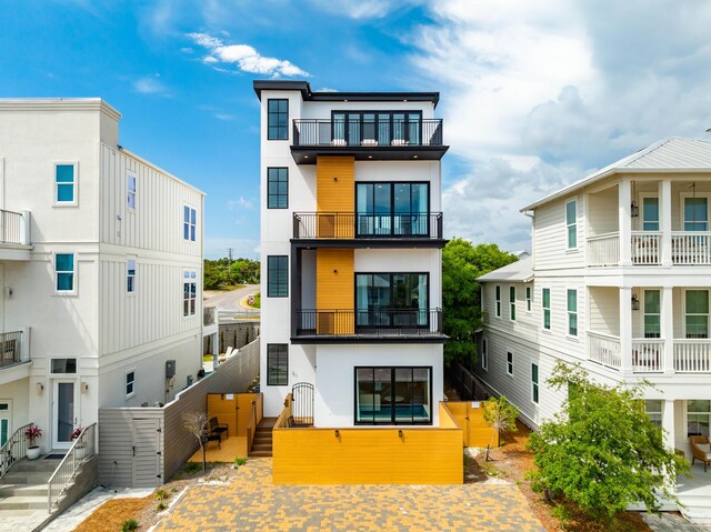 21 Tidewater Ct, Inlet Beach, FL 32461 - back of house with fence, a balcony, stucco siding, and a gate