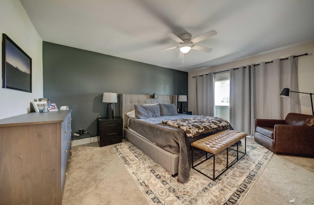 bedroom with light carpet and a ceiling fan