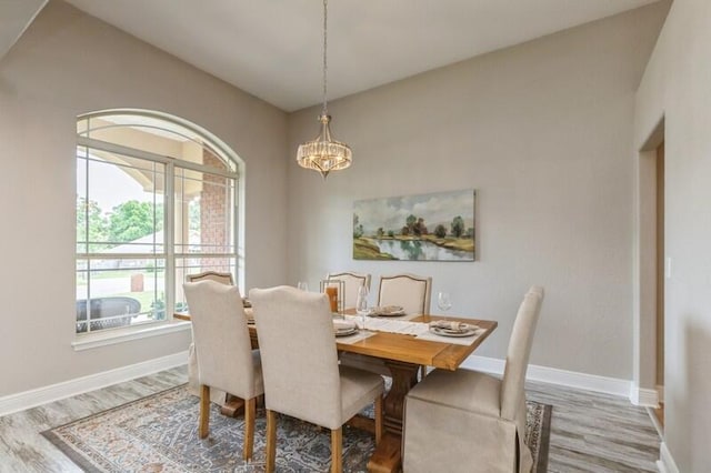 6216 Plum Orchard Way, Crestview, FL 32536 - dining room featuring wood finished floors, baseboards, and a chandelier