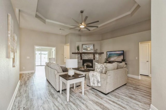 6216 Plum Orchard Way, Crestview, FL 32536 - living area featuring a ceiling fan, wood finished floors, a fireplace, baseboards, and crown molding