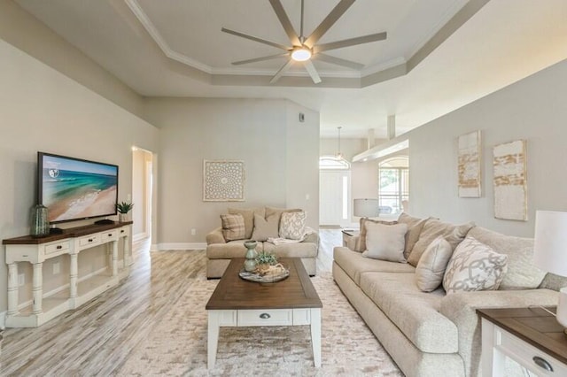 6216 Plum Orchard Way, Crestview, FL 32536 - living room with ceiling fan, light wood-style flooring, a raised ceiling, crown molding, and baseboards