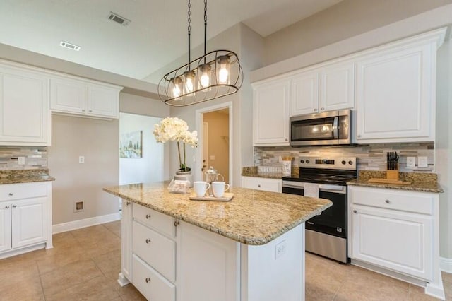 6216 Plum Orchard Way, Crestview, FL 32536 - kitchen featuring stainless steel appliances, backsplash, a center island, light tile patterned floors, and white cabinetry