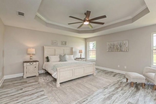 6216 Plum Orchard Way, Crestview, FL 32536 - bedroom with a raised ceiling, light wood-style floors, ornamental molding, baseboards, and ceiling fan