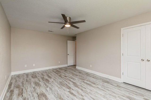 6216 Plum Orchard Way, Crestview, FL 32536 - empty room with light wood finished floors, ceiling fan, and baseboards