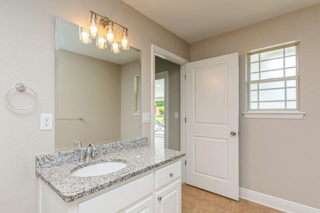 6216 Plum Orchard Way, Crestview, FL 32536 - bathroom featuring tile patterned flooring, baseboards, vanity, and a chandelier