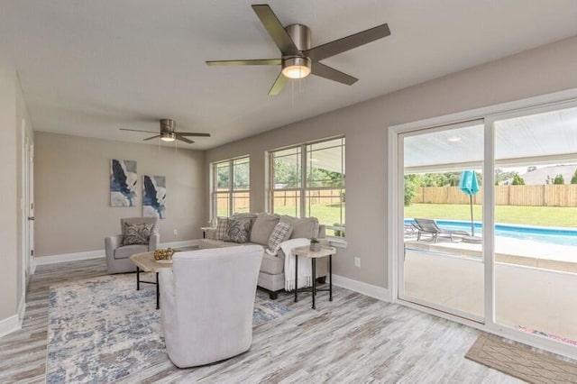 6216 Plum Orchard Way, Crestview, FL 32536 - living room featuring light wood finished floors, a ceiling fan, and baseboards