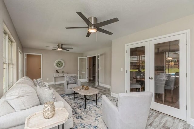 6216 Plum Orchard Way, Crestview, FL 32536 - living area with french doors, a ceiling fan, light wood-style floors, and baseboards