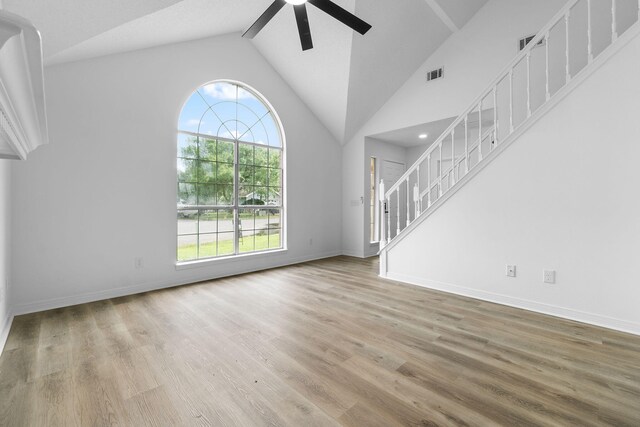 1725 Colonial Ct, Fort Walton Beach, FL 32547 - unfurnished living room with a ceiling fan, wood finished floors, lofted ceiling, stairs, and baseboards