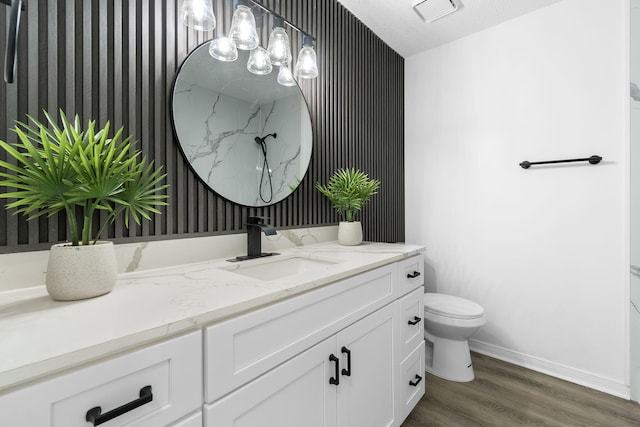 1725 Colonial Ct, Fort Walton Beach, FL 32547 - bathroom with wallpapered walls, baseboards, wood finished floors, vanity, and toilet