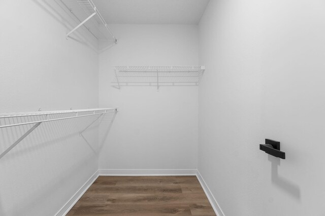 1725 Colonial Ct, Fort Walton Beach, FL 32547 - walk in closet featuring dark wood finished floors