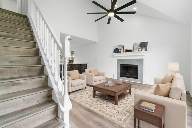 1725 Colonial Ct, Fort Walton Beach, FL 32547 - living room with ceiling fan, wood finished floors, stairs, high vaulted ceiling, and a premium fireplace
