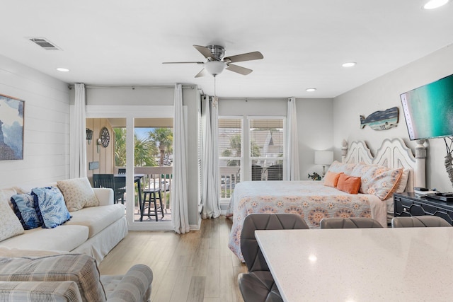 775 Gulf Shore Dr Unit 8250, Destin, FL 32541 - bedroom with access to exterior, light wood-type flooring, recessed lighting, ceiling fan, and wooden walls