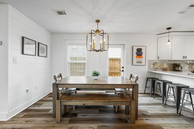 65 Brown St, Santa Rosa Beach, FL 32459 - dining space with a chandelier, wood finished floors, and baseboards