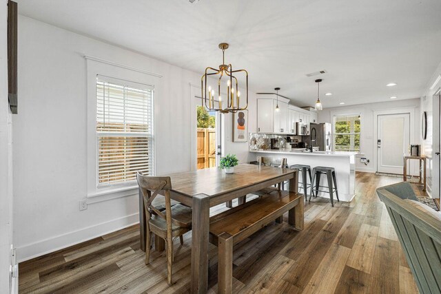 65 Brown St, Santa Rosa Beach, FL 32459 - dining room featuring a chandelier, recessed lighting, wood finished floors, and baseboards