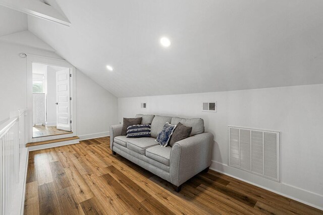 65 Brown St, Santa Rosa Beach, FL 32459 - living area with lofted ceiling, wood finished floors, and baseboards
