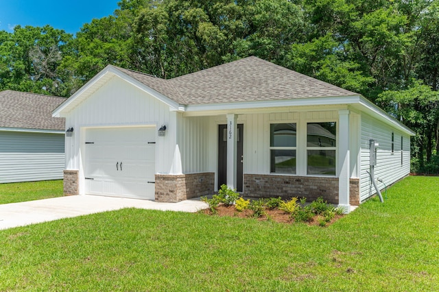 504 Lee Ave, Crestview, FL 32539 - view of front of house featuring a garage, a shingled roof, a front yard, concrete driveway, and board and batten siding