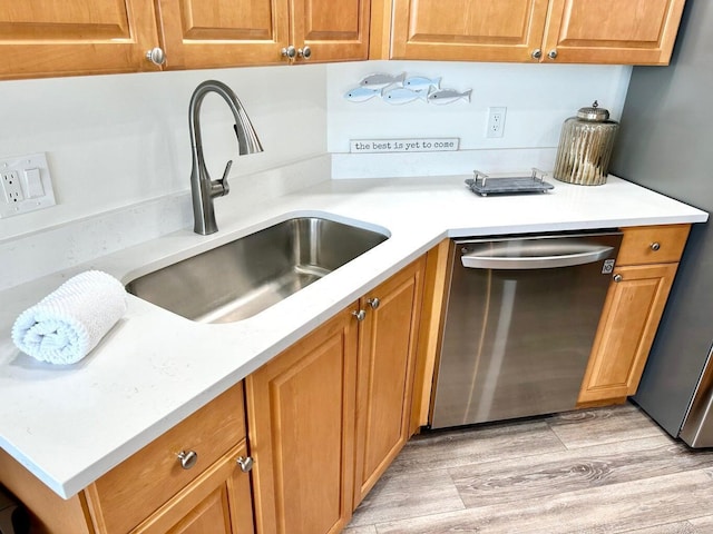 1096 Scenic Gulf Dr Ph 1610, Miramar Beach, FL 32550 - kitchen featuring stainless steel dishwasher, a sink, light countertops, and brown cabinetry