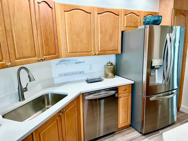 1096 Scenic Gulf Dr Ph 1610, Miramar Beach, FL 32550 - kitchen with appliances with stainless steel finishes, a sink, light wood-type flooring, and light countertops