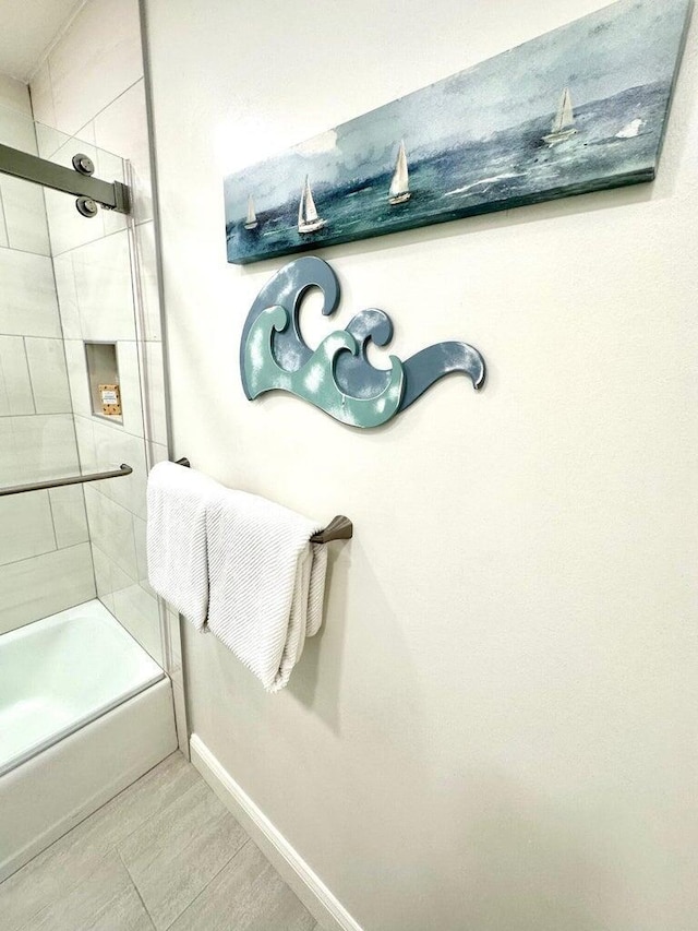 1096 Scenic Gulf Dr Ph 1610, Miramar Beach, FL 32550 - bathroom with baseboards and combined bath / shower with glass door