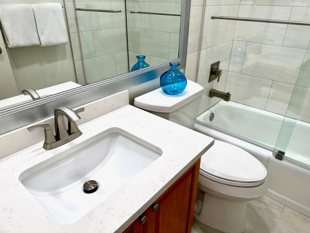 1096 Scenic Gulf Dr Ph 1610, Miramar Beach, FL 32550 - bathroom with bath / shower combo with glass door, toilet, tile patterned flooring, and vanity