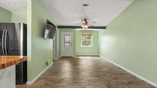 unfurnished living room with a ceiling fan, dark wood finished floors, and baseboards