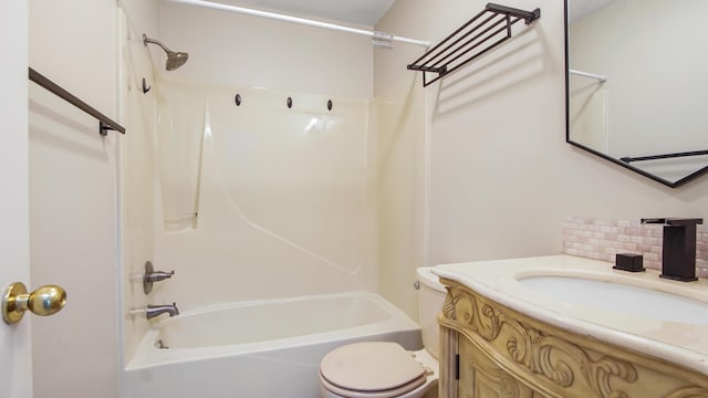 bathroom featuring decorative backsplash, washtub / shower combination, vanity, and toilet
