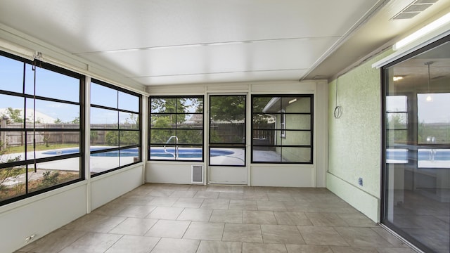 unfurnished sunroom with plenty of natural light