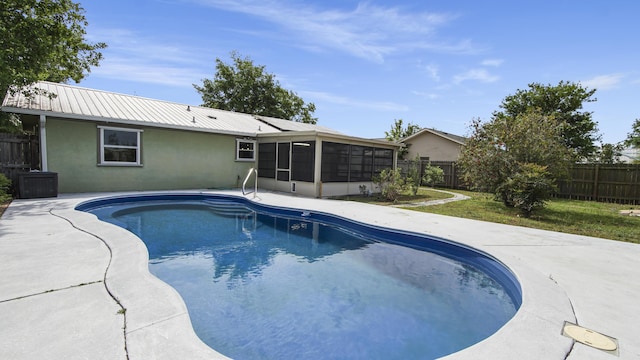 view of swimming pool featuring a sunroom, a fenced backyard, and a patio