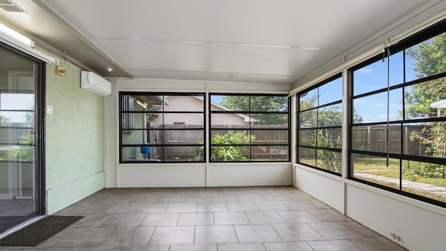 unfurnished sunroom with a wall unit AC and plenty of natural light