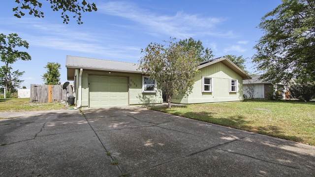 ranch-style house featuring concrete driveway, an attached garage, stucco siding, and metal roof