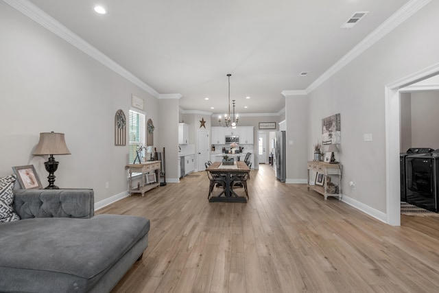living area featuring light wood-type flooring, a chandelier, baseboards, recessed lighting, and crown molding
