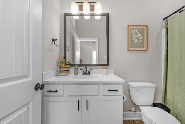 full bath featuring toilet, vanity, and a chandelier