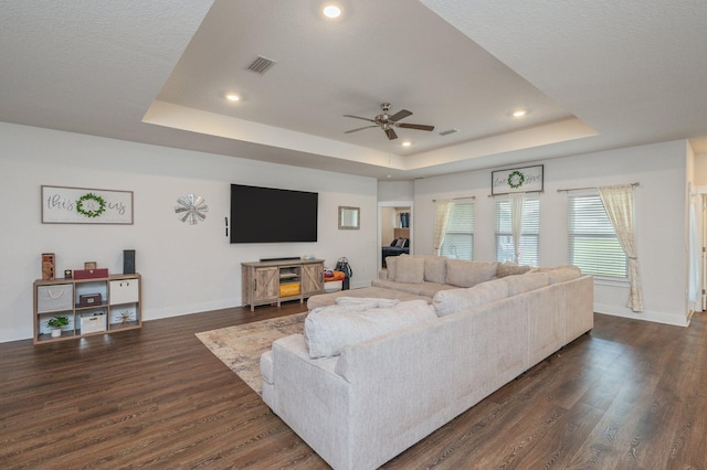 1126 Valor Walk, Crestview, FL 32539 - living area featuring a tray ceiling, a ceiling fan, dark wood-style flooring, baseboards, and recessed lighting