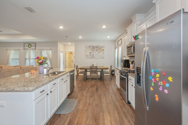 1126 Valor Walk, Crestview, FL 32539 - kitchen featuring stainless steel appliances, a sink, white cabinets, dark wood-style flooring, and recessed lighting