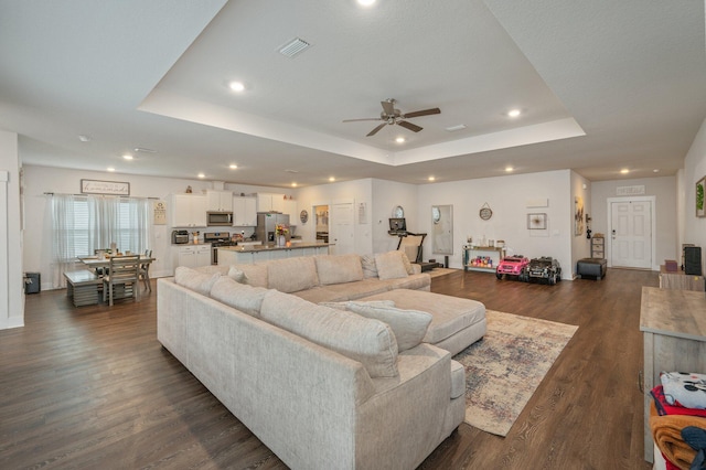 1126 Valor Walk, Crestview, FL 32539 - living area with a tray ceiling, a ceiling fan, recessed lighting, and dark wood-style floors
