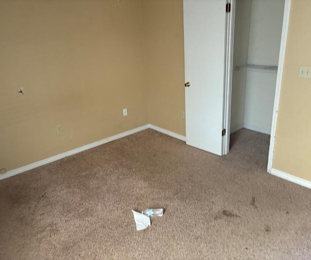 unfurnished bedroom featuring carpet flooring, a closet, and baseboards