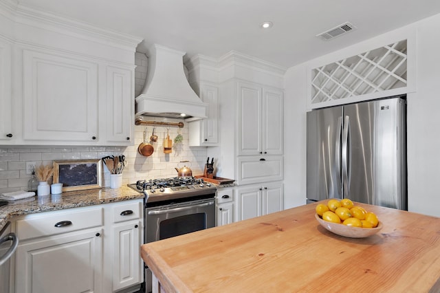 4485 Luke Ave Unit B, Destin, FL 32541 - kitchen featuring custom exhaust hood, appliances with stainless steel finishes, butcher block counters, white cabinetry, and recessed lighting