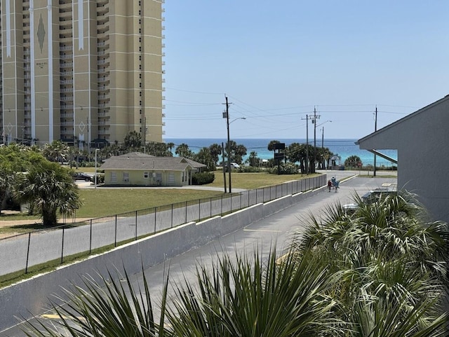 view of road with street lights and a water view