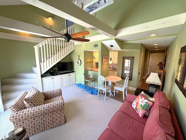 living room with carpet flooring, stairway, ceiling fan, baseboards, and high vaulted ceiling