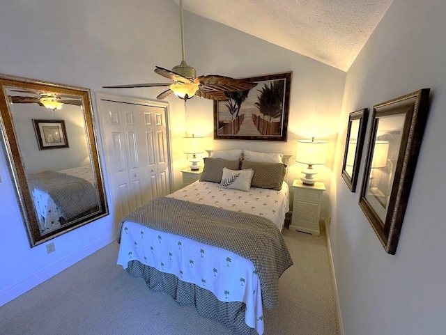 bedroom with vaulted ceiling, carpet, a closet, baseboards, and ceiling fan