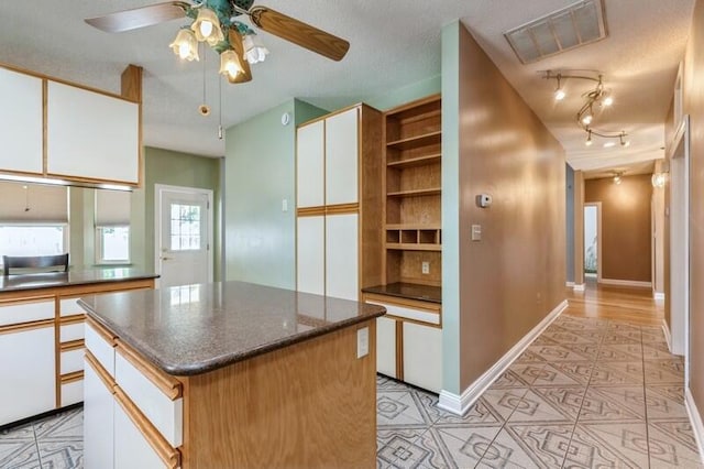 84 12th St, Shalimar, FL 32579 - kitchen with white cabinets, a ceiling fan, light tile patterned floors, baseboards, and open shelves