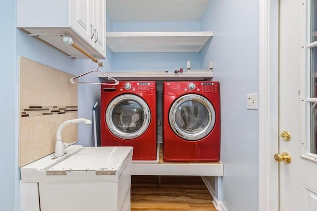 84 12th St, Shalimar, FL 32579 - laundry room with washer and clothes dryer, cabinet space, and wood finished floors