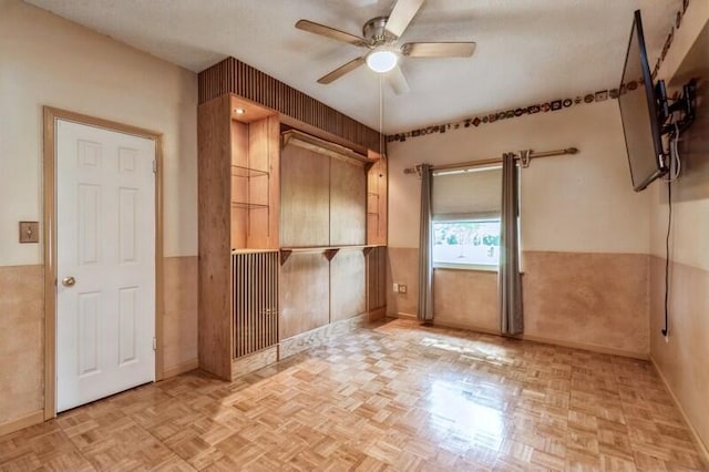 84 12th St, Shalimar, FL 32579 - empty room featuring ceiling fan and a wainscoted wall