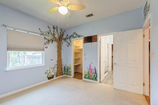 84 12th St, Shalimar, FL 32579 - unfurnished bedroom with carpet, a walk in closet, baseboards, and a closet