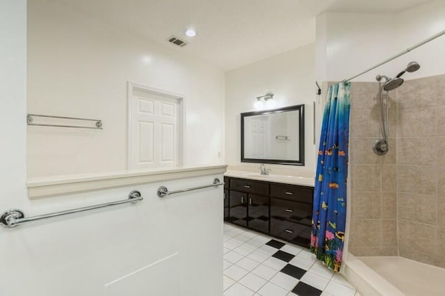 84 12th St, Shalimar, FL 32579 - bathroom featuring tiled shower, vanity, and tile patterned floors