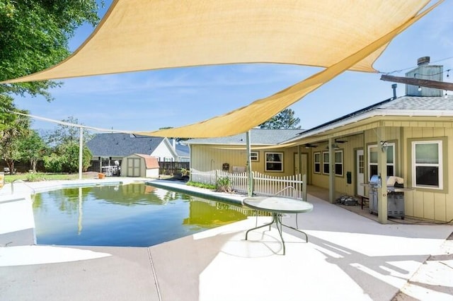 84 12th St, Shalimar, FL 32579 - view of pool with a grill, a patio area, a storage unit, an outbuilding, and a ceiling fan