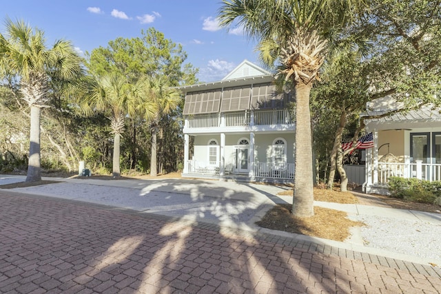 view of front of home featuring covered porch, a balcony, and stucco siding