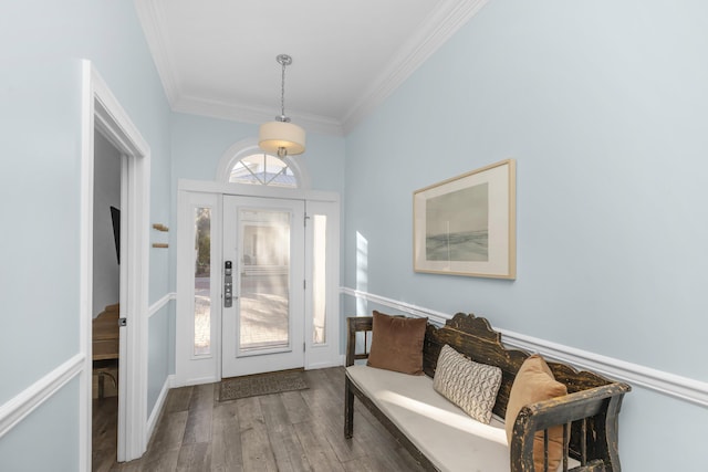 foyer entrance with crown molding and wood finished floors