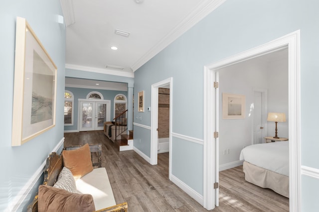 hall featuring ornamental molding, wood finished floors, french doors, baseboards, and recessed lighting