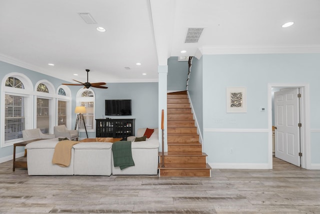 living room with ornamental molding, recessed lighting, stairs, wood finished floors, and baseboards